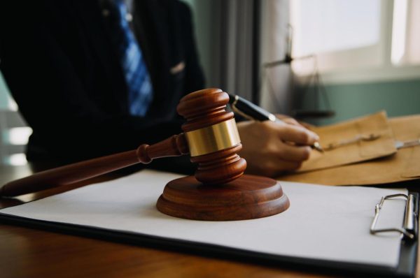 business-and-lawyers-discussing-contract-papers-with-brass-scale-on-desk-in-office-law-legal-services-advice-justice-and-law-concept-picture-with-film-grain-effect-free-photo