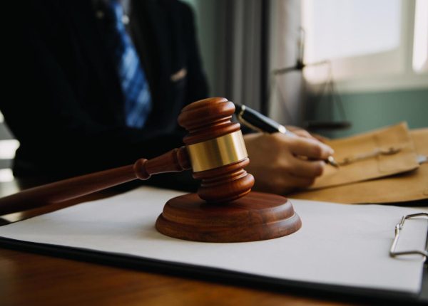 business-and-lawyers-discussing-contract-papers-with-brass-scale-on-desk-in-office-law-legal-services-advice-justice-and-law-concept-picture-with-film-grain-effect-free-photo